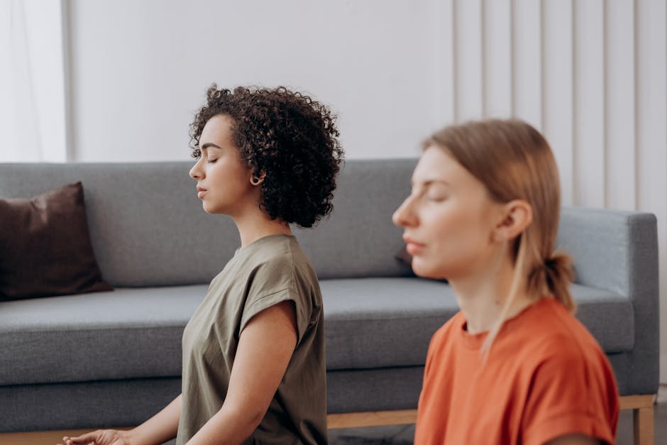 Woman practicing a gentle evening yoga pose in a softly lit, serene room